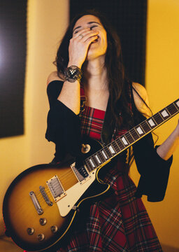 Female model smile with electric guitar