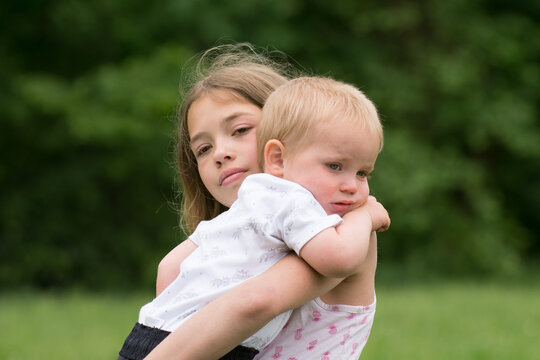 Crying children, sad siblings - sister with little baby brother.
