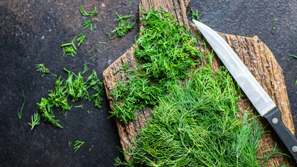 dill fresh green bunch of spicy herbs cut finely with a knife on the table, healthy food meal snack copy space food background rustic. top view keto or paleo diet veggie vegan or vegetarian 