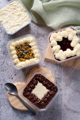 Variety of cake in the pot for delivery. Strawberry, passion fruit, chocolate and coconut flavor. Top view.
