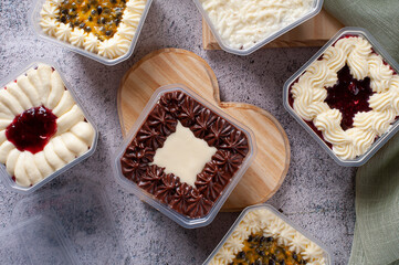 Variety of cake in the pot for delivery. Strawberry, passion fruit, chocolate and coconut flavor. Top view.