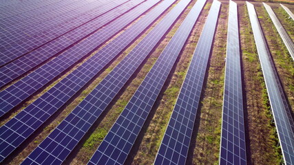 Aerial drone view flight over solar power station panels.