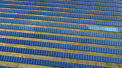 Aerial drone view flight over solar power station panels.