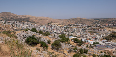 Fototapeta premium Panoramic view of Majdal Shams, a Druze town in the southern foothills of Mt. Hermon, north of the Golan Heights, Israel.