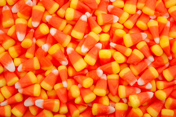 Nostalgic American tradition, iconic trick or treat sweets and Halloween backgrounds concept with full frame of many candy corn pieces with copy space