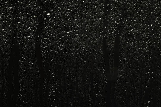 Glass With Rain Drops On Black Background