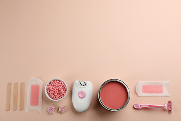 Set of epilation products on beige background, flat lay. Space for text