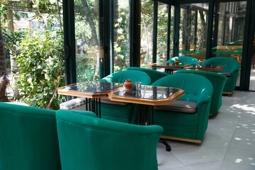 Fototapeta na wymiar An open, cozy cafe on a glassed-in terrace.