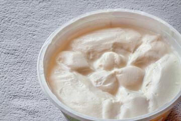 Close-up cream cottage cheese white bowl grey concrete dackground