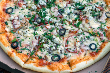 Close-up of hot pizza in a box on the table