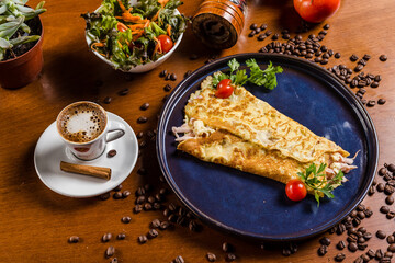 Perfect Breakfast Tapioca Toasted Cheese on a blue plate with Coffee Cinnamon and Salad over a Wooden Table with Coffee Beans