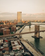 Fototapeta premium View of the East River with Manhattan and Brooklyn Bridges at sunset, from the Financial District, Manhattan, New York City