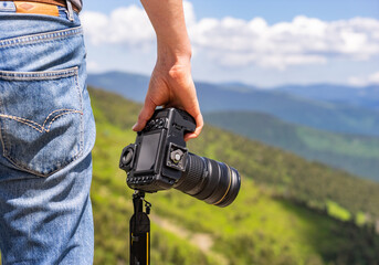 Photographer with camera in the mountain