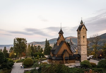 Fototapeta na wymiar Old wooden Church against the backdrop of the Polish mountains