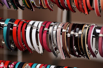 Leather multi-colored bracelets hang in a row on the window of a souvenir shop for tourists. Russia Kazan 24.04.2021. High quality photo