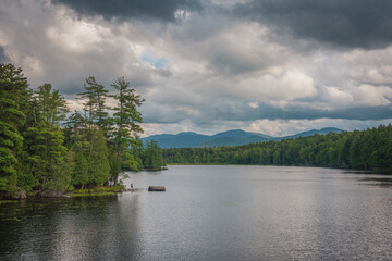 A lake with trees and mountains in the background, Adirondack Mountains, New York