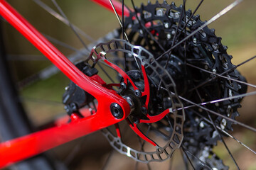 Rear wheel disc brake rotor of the grey sport bike close up on the grey background