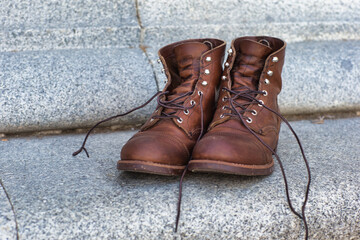 Old man used boots over stone