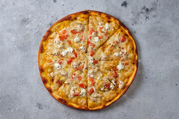 Pizza with tomatoes, chicken, onions, feta cheese, mozzarella cheese and spices. Flat lay. On a light background