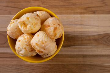 bowl with cheese breads on wooden table