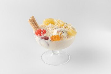 ice cream bowl with fresh frozen yogurt, fruits, cookies, pineapple isolated on a white and gray background with natural shadows