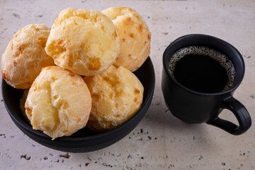 delicious cheese breads and a cup of coffee on white marble