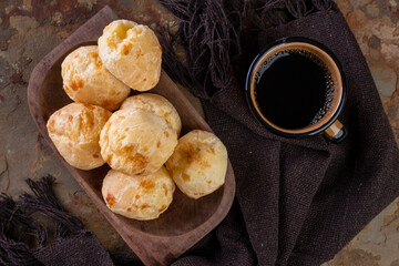 delicious cheese breads and a cup of coffee - top view