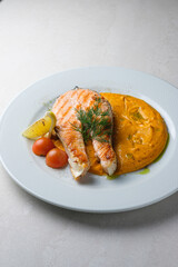 Menu for the restaurant: Trout steak served with carrot and potato puree.
