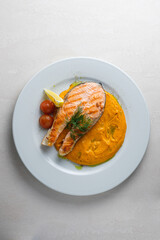 Menu for the restaurant: Trout steak served with carrot and potato puree.
