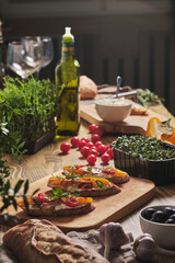 Breakfast in Italian for a loved one on a holiday. Bruschetta with cream cheese and baked vegetables, garnished with microgreens.