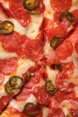 Pepperoni pizza with jalapeno peppers. A closeup of a pizza.