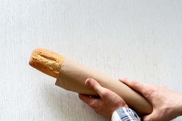 cook packing the fresh baked bread into the paper