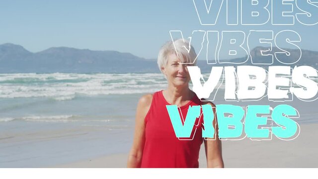 Animation of text vibes, in white and blue, with happy senior woman on beach