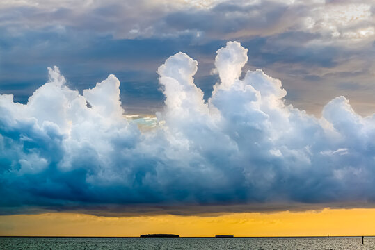 Stunning backdrop of stormy multidimensional clouds over the sea during a sunset.