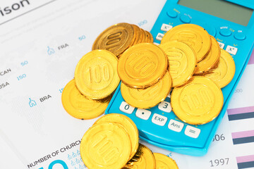 Gold coins and calculator on documents