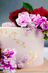 Beautiful Wedding cake with flowers on table and black background.