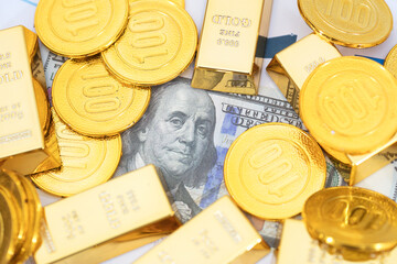 U.S. dollar bills covered by gold bars and coins © zhenya