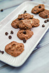 Chocolate crunchy cookies with background decoration. Selective focus.