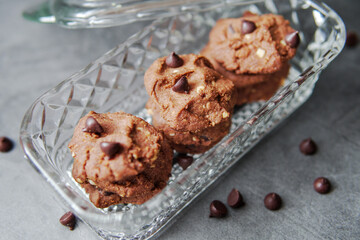 Chocolate crunchy cookies with background decoration. Selective focus.