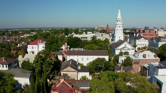 Aerial truck shot. Charleston SC. Broad Street above Old Exchange and Provost Dungeon. St. Michael's Episcopal Church steeple. Downtown historic city establishing shot.