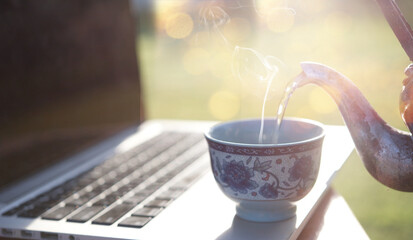 Hot water with smoke from the old kettle on laptop.