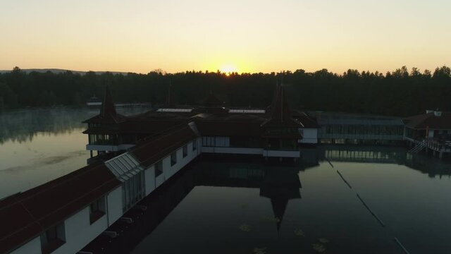 Aerial drone shot of wonderful Lake H&eacute;v&iacute;z at sunrise with sun over the horizon in background