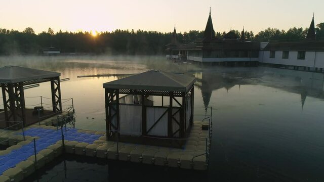 Aerial drone shot of wonderful Lake H&eacute;v&iacute;z at sunrise with sun over the horizon in background