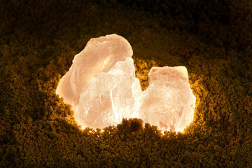 Glowing orange crystal rock in the dark.