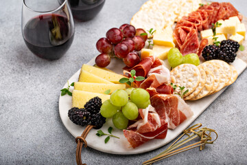 Summer charcuterie board with cheese, meat and fruit