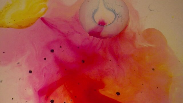 Psychedelic multi-colored ink flows and oscillates in a liquid light show.