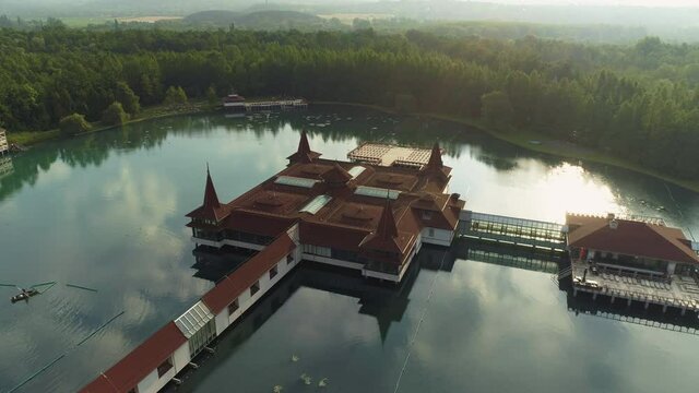 Aerial drone shot of wonderful Lake H&eacute;v&iacute;z at sunrise with sun over the horizon in background