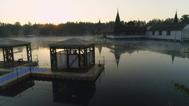 Aerial drone shot of wonderful Lake H&eacute;v&iacute;z at sunrise with sun over the horizon in background