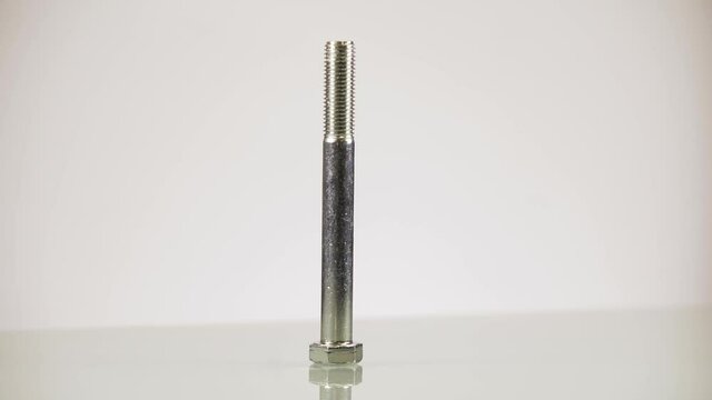 Steel screw rotating on white background isolated