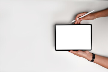 Top view woman holding mock up digital tablet.